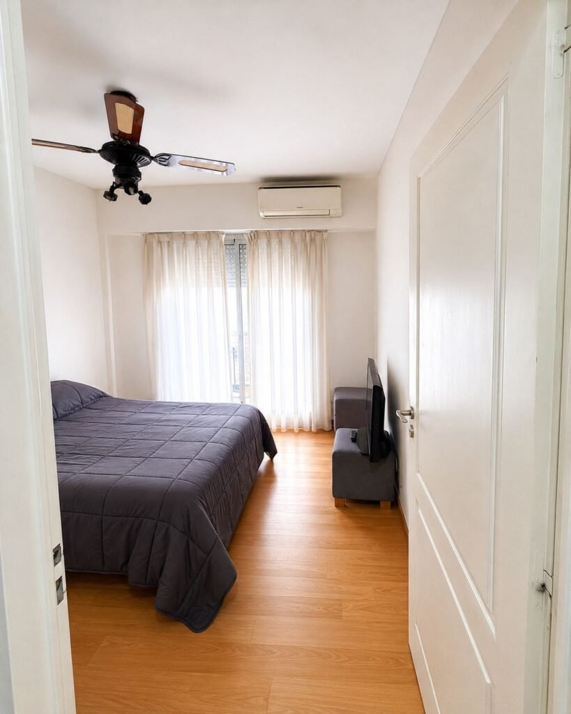 a_bright_minimalist_bedroom_viewed_from_the_doorwa_1_batch_1